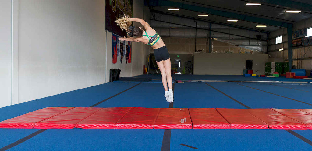 Rebound-Delay Gymnastics Mats: Controlling Energy Return After Impact